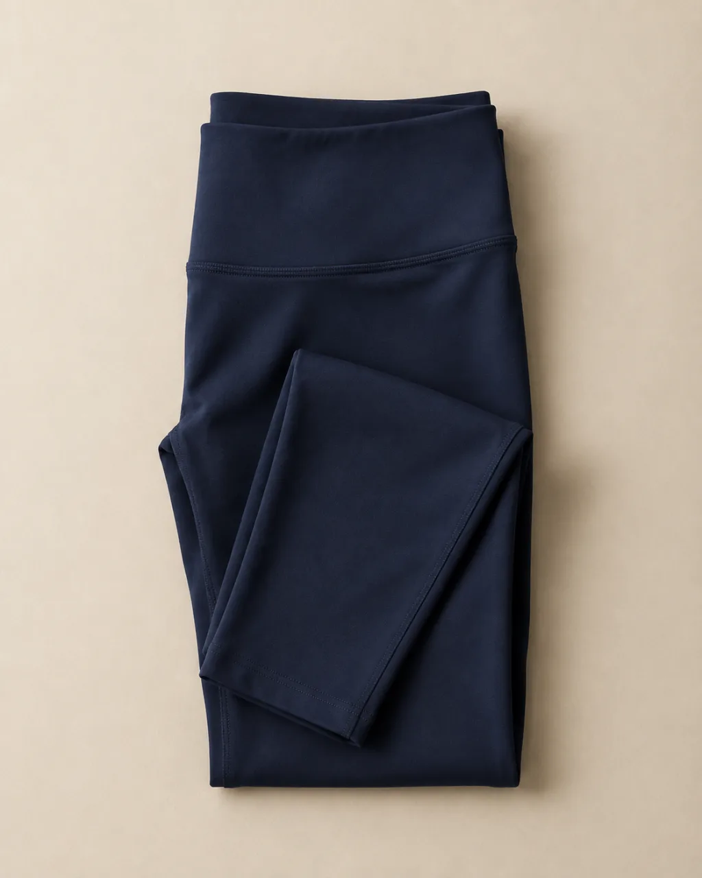 a pair of leggings folded in thirds, waistband facing the camera with a high rise and a full elastic waistband , fabric: VitaFree fabric with added LYCRA fibre