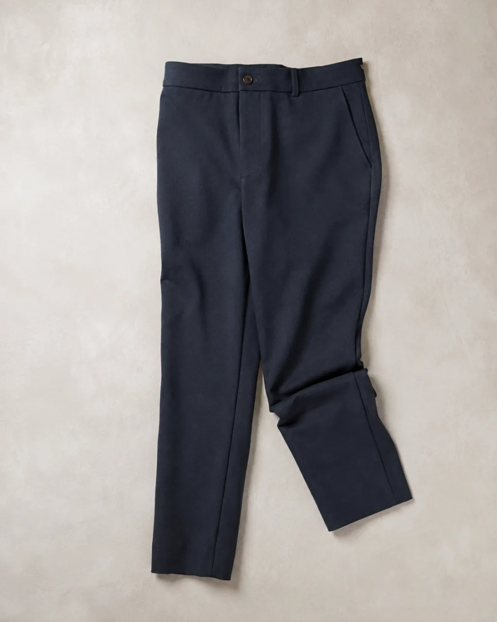 a pair of ponte knit pants folded once at the knee and laid flat with a button-and-zip waistband , fabric: Ponte double-knit