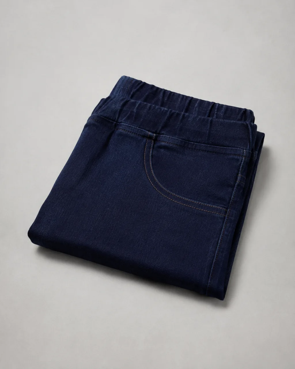a pair of jeggings neatly folded into a square stack, waistband on top with a mid rise and a full elastic waistband , fabric: Cotton/Lycra blend