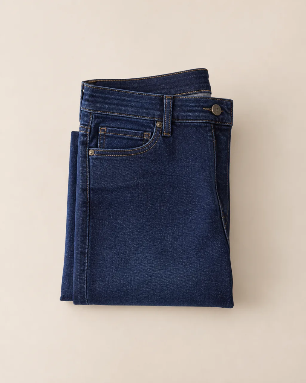 a folded, flat-laid pair of stretch jeans with a mid rise