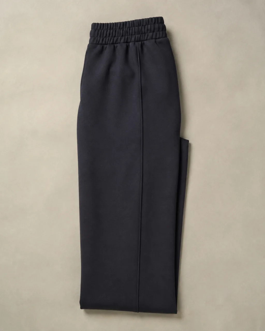 a pair of ponte knit pants folded in half lengthwise, side seam running down the frame with a high rise and a full elastic waistband , fabric: Ponte knit