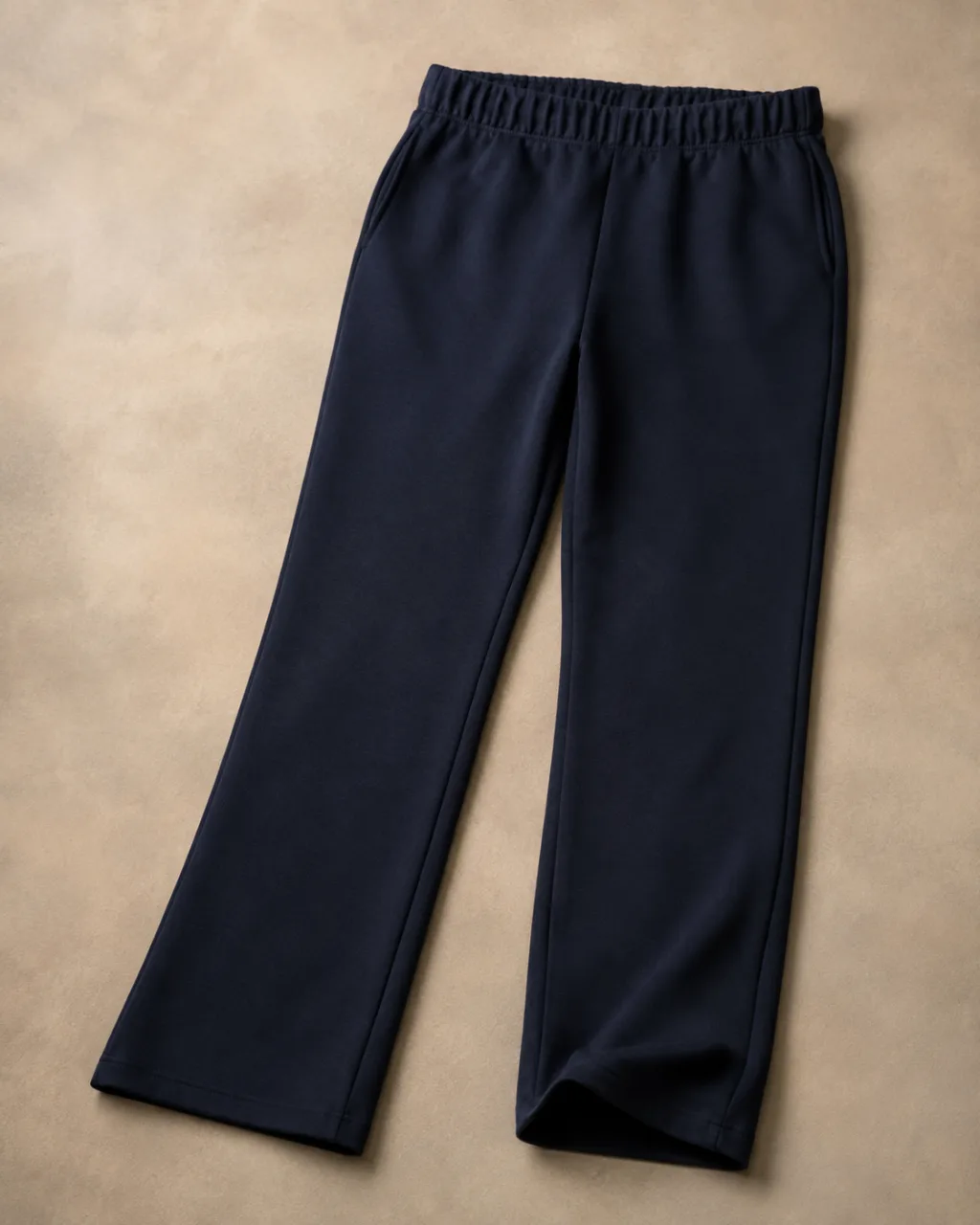 a pair of ponte knit pants laid flat full length with a single soft fold at the hem with a high rise and a full elastic waistband , fabric: Ponte knit