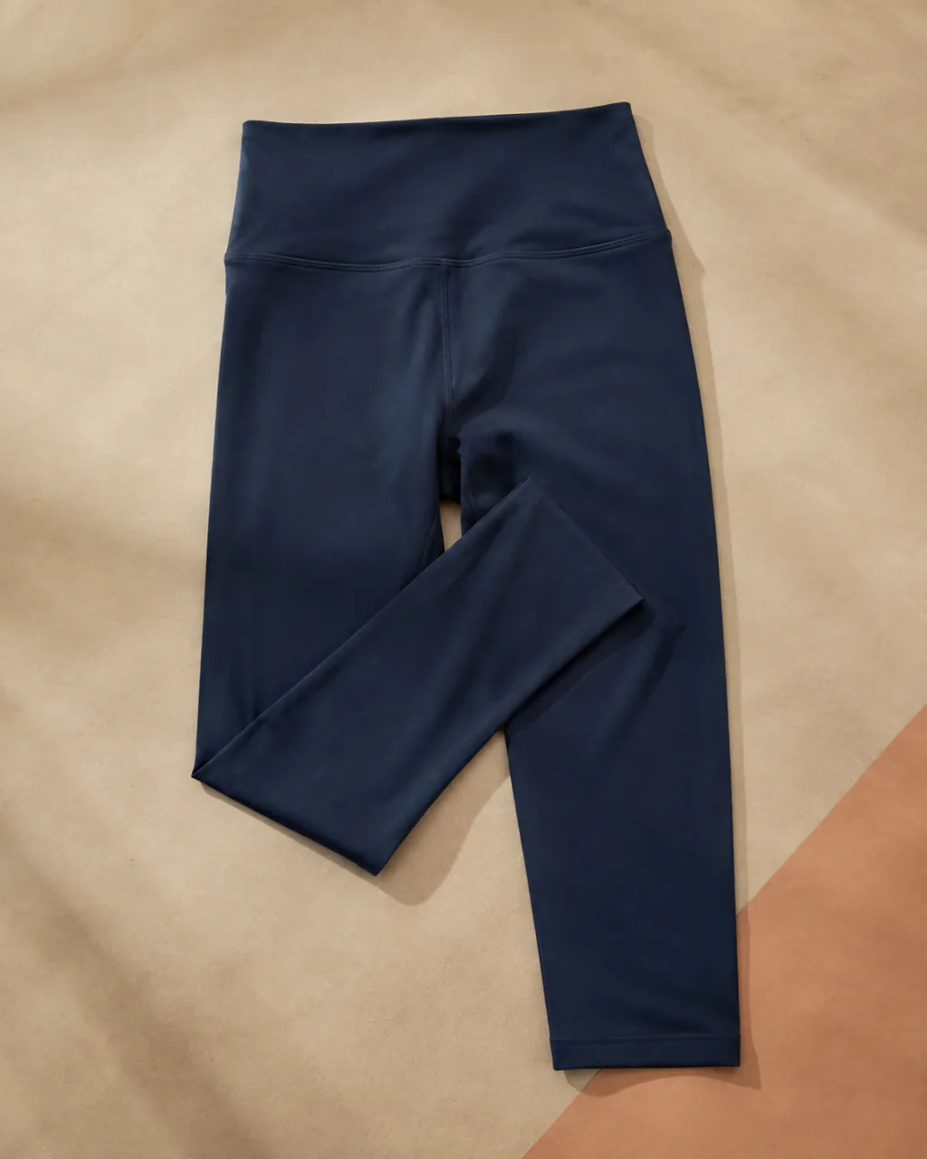 a pair of leggings laid flat with one leg folded back across the other with a full elastic waistband , fabric: FlexAppeal performance fabric