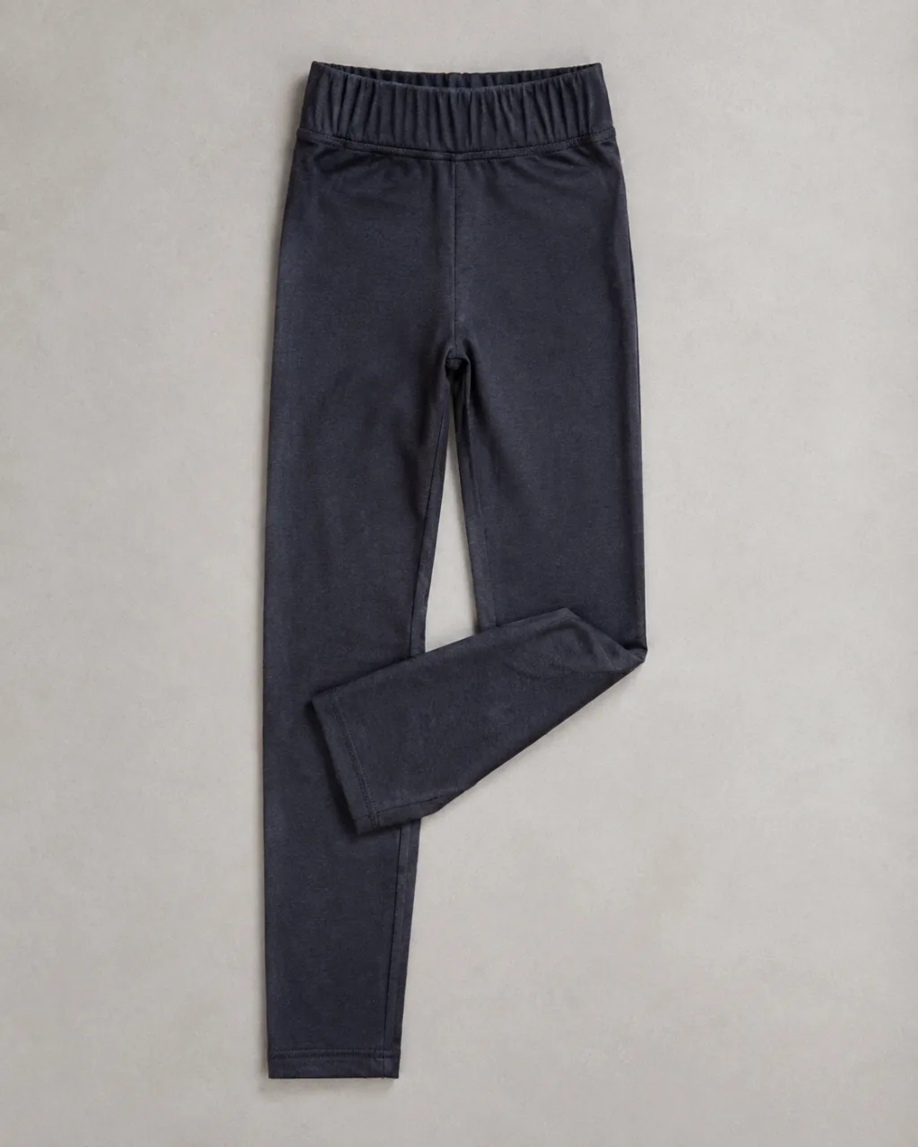 a pair of leggings folded once at the knee and laid flat with a full elastic waistband