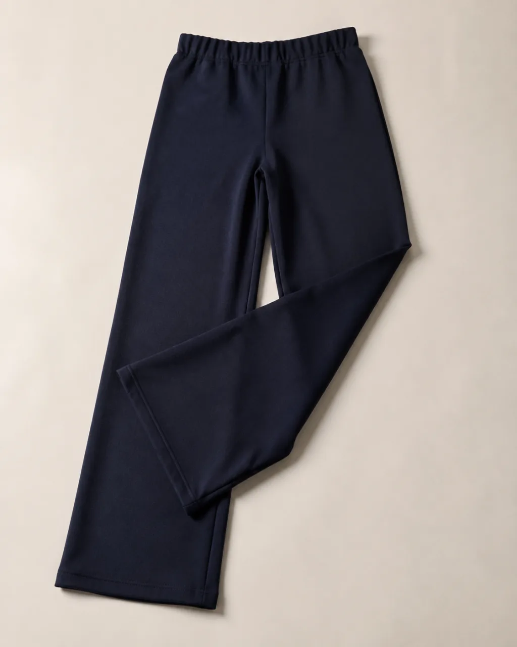 a pair of ponte knit pants laid flat with one leg folded back across the other with a high rise and a full elastic waistband , fabric: Ponte knit