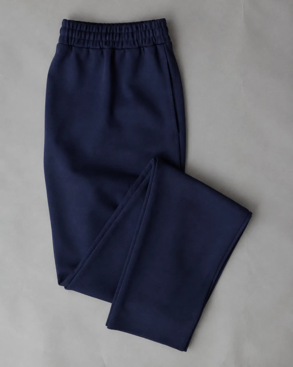a pair of ponte knit pants folded once at the knee and laid flat with a full elastic waistband , fabric: Ponte knit
